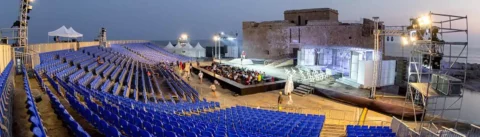 Nighttime opera performance at the 23rd Pafos Aphrodite Festival with the Medieval Castle of Pafos illuminated by stage lights