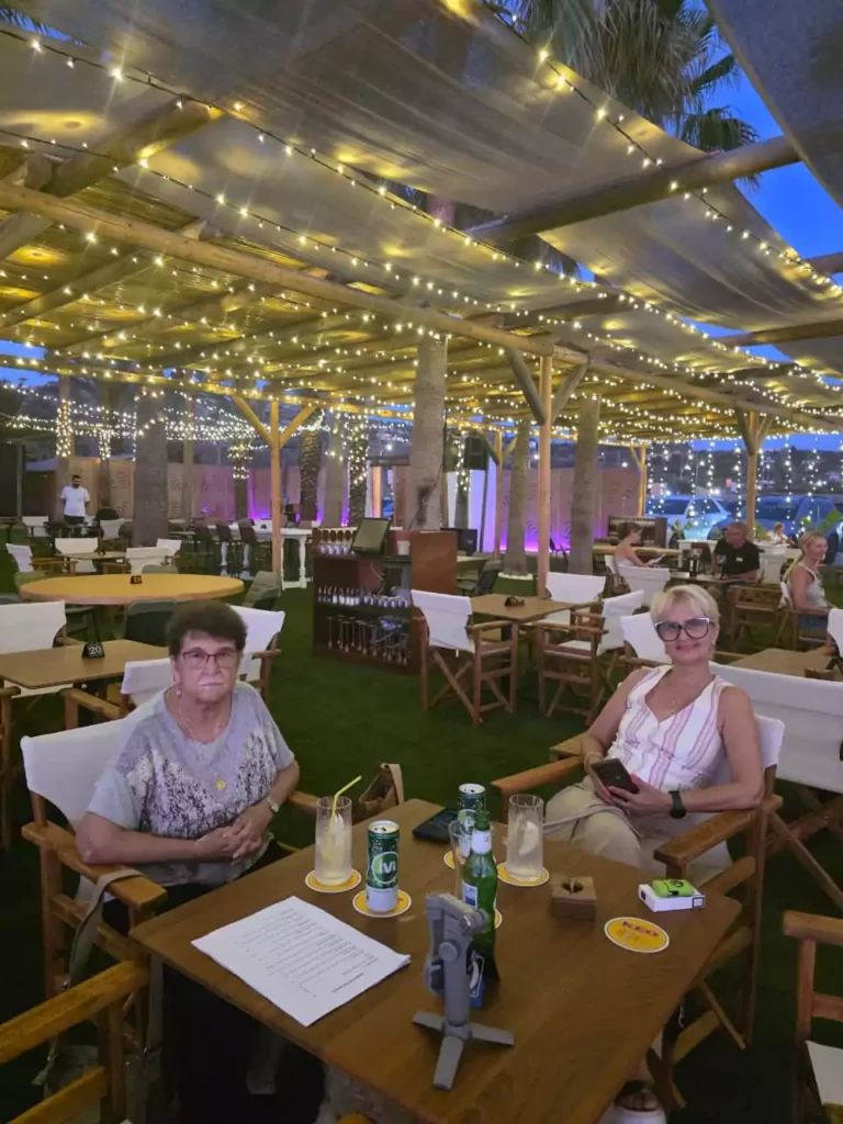 Customers at Sense by the Beach savoring delicious dishes and drinks, surrounded by a lively atmosphere and beautiful beach views.